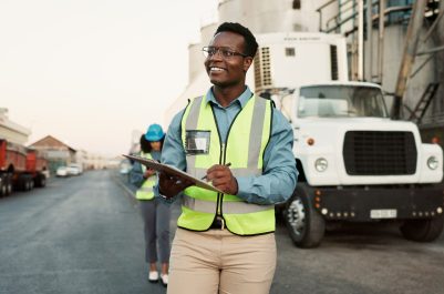 Industrial, outdoor and black man with clipboard in logistics for inspection, inventory check or delivery schedule. Shipping, checklist and employee for distribution, supply chain or quality control.